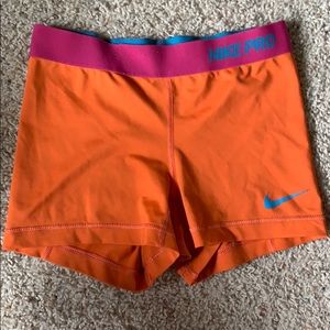 Orange and pink nike pros